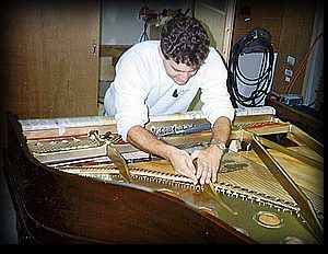 A man tuning a piano.