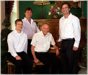 Taylor Piano Restoration staff in front of a piano.